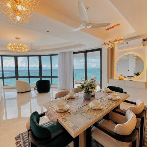 a dining room with a table and chairs at Escape Reef in Watamu