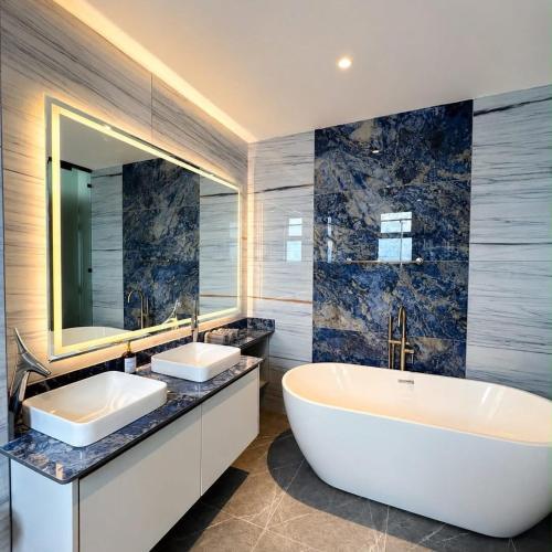 a bathroom with two sinks and a large tub at Escape Reef in Watamu