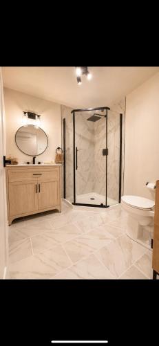 a large bathroom with a shower and a toilet at Modern private apartment - Warm atmosphere in Repentigny