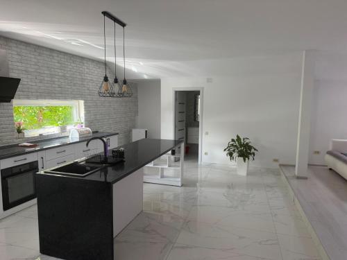 a kitchen with a black counter top in a room at AME Home Apartament 2 in Ocna-Mureşului