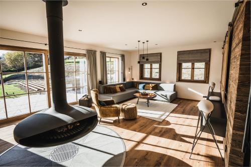 a living room with a wood burning stove in the middle at Chalet am Wetterkreuz in Reit im Winkl