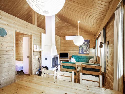 a living room with wooden walls and a wooden ceiling at Holiday Home Naavarinne by Interhome in Muonio