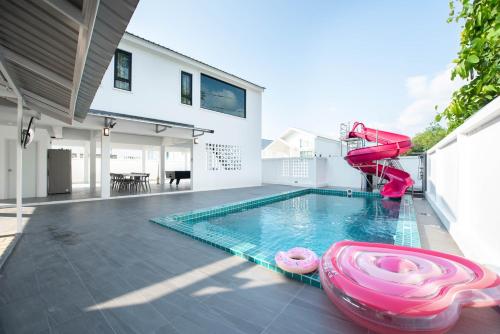 a pool with a water slide in a house at Amornrut Hill 03 in Ban Tao Than