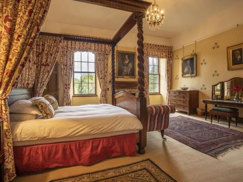 a bedroom with a canopy bed and a piano at Apartment Macduff Tower by Interhome in Angus