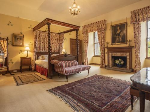 a bedroom with a canopy bed and a fireplace at Apartment Macduff Tower by Interhome in Angus