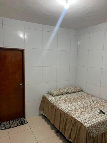 a bedroom with a bed and a light on the ceiling at Villa do mar Praia de Iracema in Fortaleza
