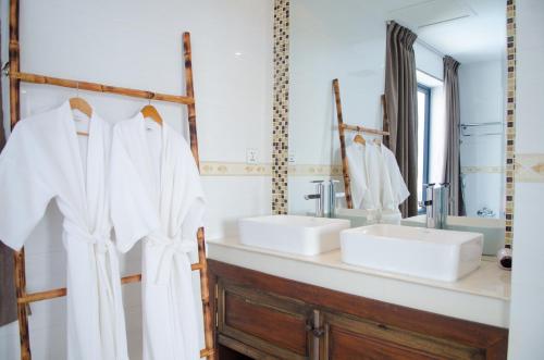 a bathroom with two sinks and two mirrors at Hotel Five.S in Kampot