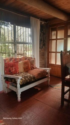 a couch sitting in a room with windows at La Agraria in Junín