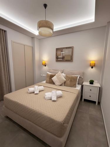 a bedroom with a large bed with towels on it at City Vibes Corinth in Korinthos