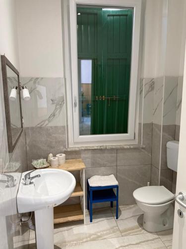 a bathroom with a sink and a toilet and a mirror at Rooms Vincanto in Salsomaggiore Terme
