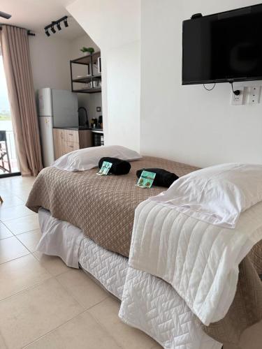 a bedroom with a bed and a flat screen tv at Apart Ogaraity Hotel in Goya