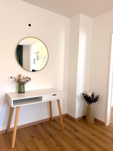 a white dressing table in a room with a mirror at Apartments Chloe - Top 1 in Hollabrunn