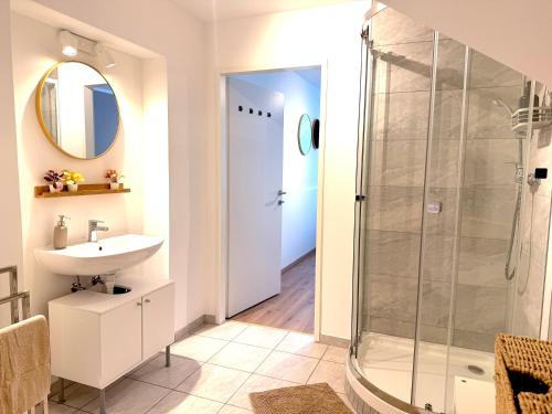 a bathroom with a shower and a sink at Apartments Chloe - Top 1 in Hollabrunn