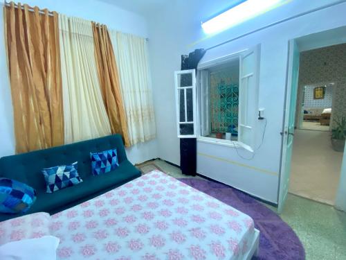 a bedroom with a bed and a window at Dar El Mdina in Mahdia