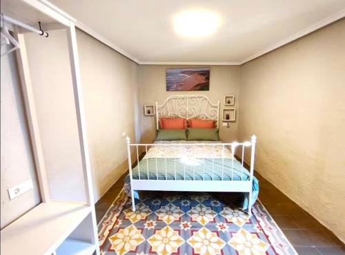 a bed in a room with a tile floor at Casa reformada centro de Lliria in Lliria