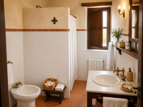 a bathroom with a sink and a toilet at Casa Rural Canchalejo in Montánchez