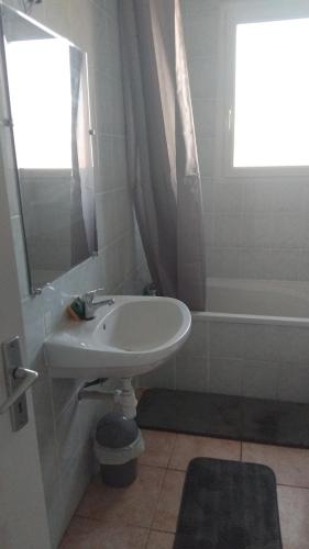 a bathroom with a sink and a bath tub at maison bozouls in Bozouls