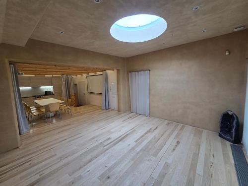 an empty room with a table and a ceiling at Wellness apartmán Habánská in Pouzdřany