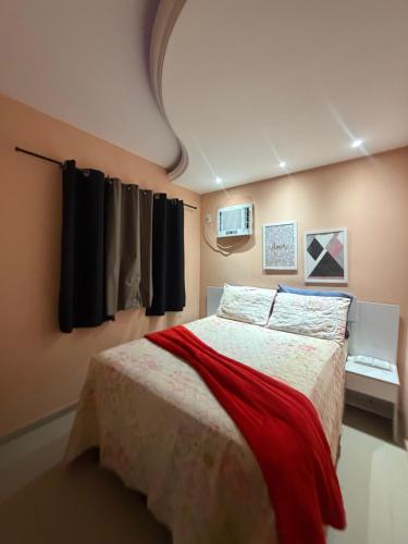 a bedroom with a bed with a red blanket at Apartamento centro de Paulista-Pe in Paulista