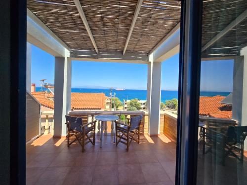 a balcony with a table and chairs and the ocean at Chios Shallow Sea in Karfas