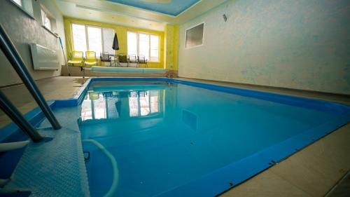 a large swimming pool in a room with at Chata Motocentrum in Snina