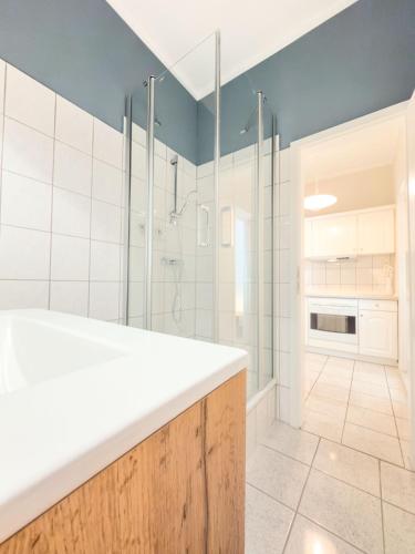 a bathroom with a sink and a shower at Villa Victoria in Binz