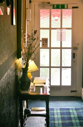 a table with a lamp and a vase on it at The Fairmile in Lytham St Annes