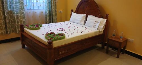 a bedroom with a bed with heart decorations on it at Matui House in Kinyasini