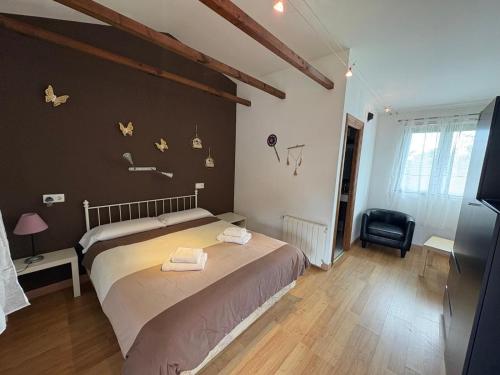 a bedroom with a large bed and a black wall at Aldea del Trasgu in Cuerres