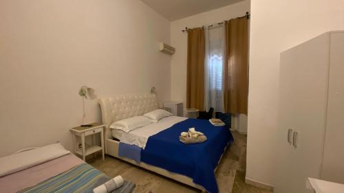 a bedroom with a bed with a teddy bear on it at Ill Balcone sullo stretto in Reggio di Calabria