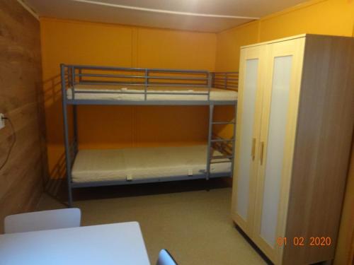 a room with two bunk beds and a cabinet at Non-stop Stellplatz Božanov in Božanov