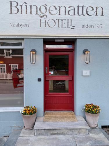 a red door on the front of a hotel at Bringenatten Hotell Nesbyen in Nesbyen
