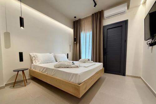 a bedroom with a bed and a black door at GLEN Premium Stays in Kanali