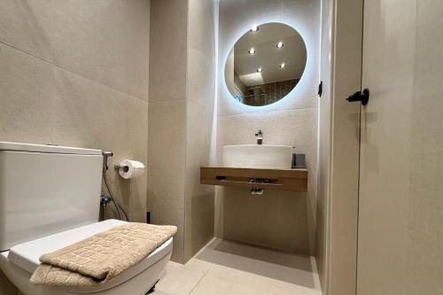 a bathroom with a sink and a mirror at GLEN Premium Stays in Kanali