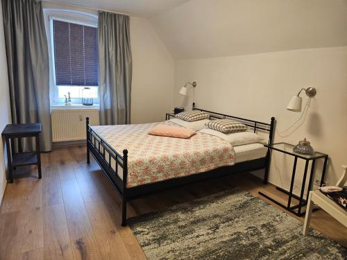 a bedroom with a bed and a window at Alte Schule Ragow in Ragow