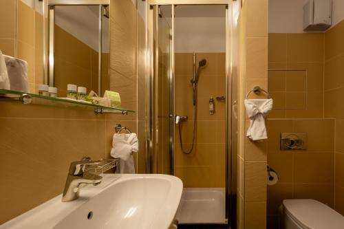 a bathroom with a sink and a shower at Hotel Bystrá in Brezno