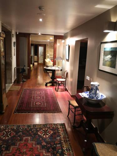 a living room with a rug on a wooden floor at Quinta do Mosteiro in Felgueiras