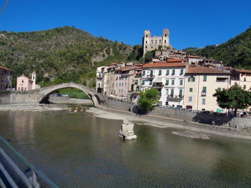 a bridge over a river in a city with buildings at Panoramic Apartment with Balcony and Terrace in Pigna