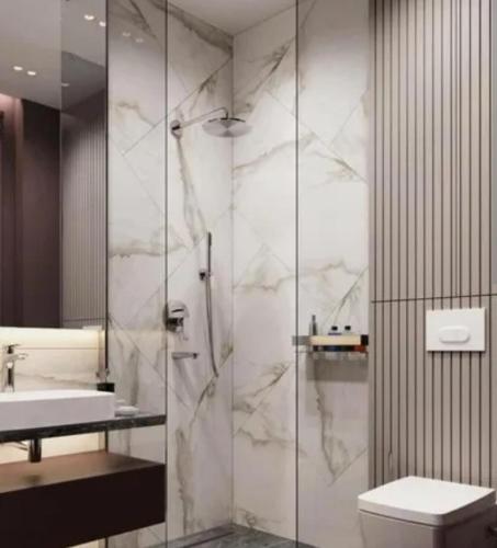 a bathroom with a shower and a toilet and a sink at The velvet pines in Mukteshwar