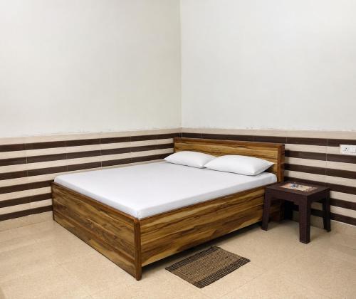 a bed with two pillows on it in a room at Shri Nimbark Mohini Kunj in Vrindāvan