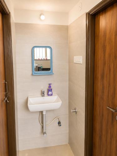 a bathroom with a sink and a mirror at Elite Nest Stay in Nashik