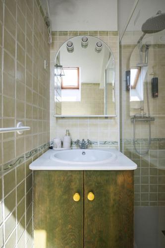 a bathroom with a sink and a mirror at Apto Aloha Panticosa | Piscina | WIFI | Vistas in Panticosa