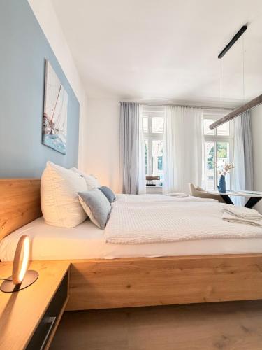 a bedroom with a large bed with a wooden headboard at Villa Victoria in Binz