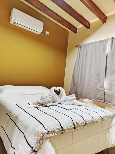 a bed with a stuffed animal on top of it at Alojamiento Las Termas in Fiambalá