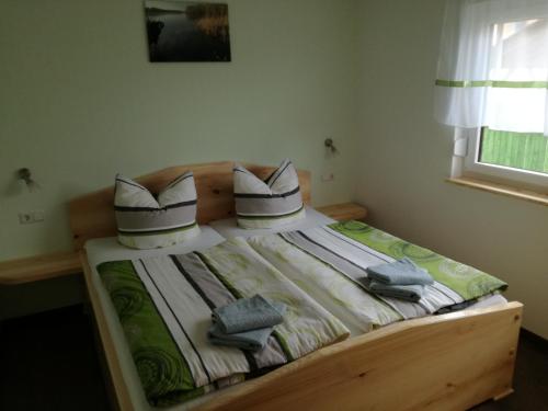a bed with two pillows on it in a bedroom at Bungalow Schwielochsee in Schwielochsee
