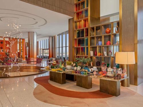 a lobby with a large library with a lot of books at SO Ras Al Khaimah Hotel & Resort-Ultra All Inclusive in Ras al Khaimah