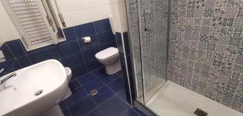 a bathroom with a toilet and a sink and a shower at Locanda a Bosco in Bosco