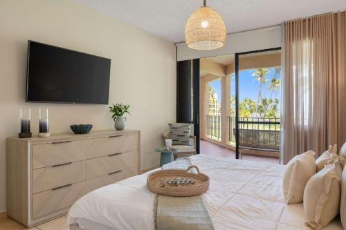 a bedroom with a large bed with a flat screen tv at Boho 2BR Retreat - Ocean View Terrace & Pool in Buena Vista
