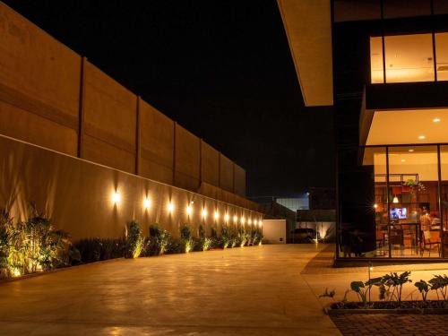 a row of lights on the side of a building at night at ibis Jaú in Jaú