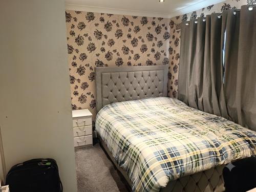 a small bedroom with a bed with a plaid blanket at Dublin Cosy Home in Dublin